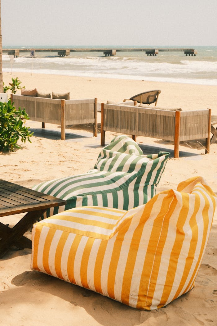 Cozy striped bean bags on Phan Thiet beach, perfect for relaxing by the sea.