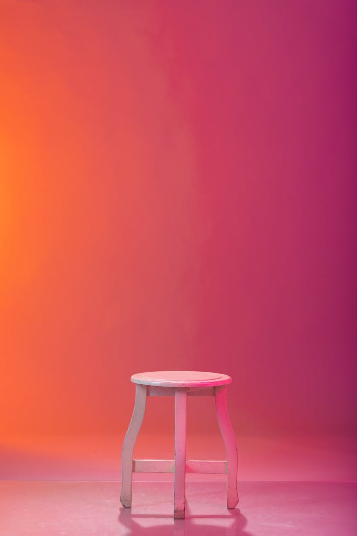 White stool against vibrant gradient background, perfect for copyspace.